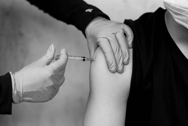 Intramuscular vitamin b12 injection into the shoulder area.